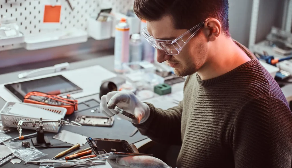 The technician uses a magnifying glass